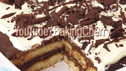 Chocolate Layered Dessert Recipe. A smooth and delicious chocolate cream, layered between ladyfinger cookies dipped in a milk mixture, topped with white chocolate ganache and semi-sweet chocolate shavings. A quick and easy dessert, perfect for any occasion!